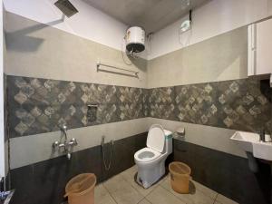 a bathroom with a toilet and a sink at Greens Vista Wayanad - Premium Homestay Near Natural Stream in Panamaram