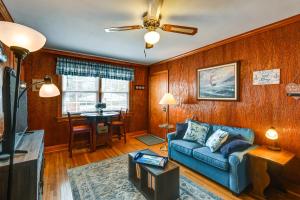 a living room with a blue couch and a table at Pet-Friendly Nashville Home about 4 Mi to Airport! in Nashville