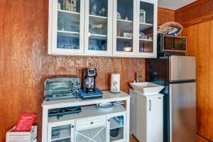 a kitchen with a white cabinet and a refrigerator at Pet-Friendly Nashville Home about 4 Mi to Airport! in Nashville