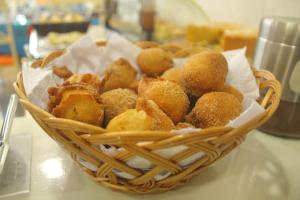 a basket filled with donuts sitting on a table at Hotel Netto in Cachoeiras de Macacu