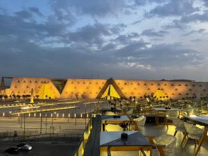 a view of a building with tables and chairs at Royal Great Pyramid INN in Cairo