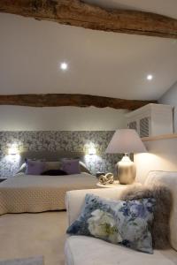 a bedroom with two beds and a lamp and a couch at Girauderies Chambres d'Hotes/B+B in Floirac