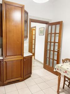 a kitchen with a large wooden cabinet and a table at Cleo Azalea in Ancona