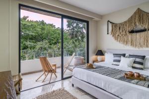 a bedroom with a bed and a large window at Fast-Wifi Sunset Studio Tulum with Rooftop and Pool SPA in Tulum +19 photos