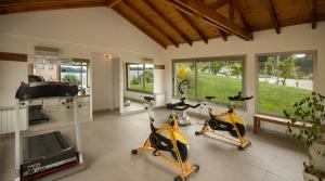 a gym with two exercise bikes and a piano at Great 2-Bedroom Apartment close Playa Bonita QL5 by Apartments Bariloche in San Carlos de Bariloche