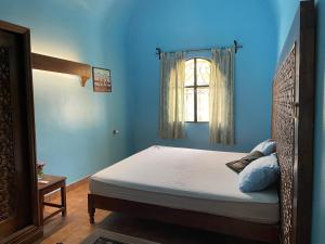 A bed or beds in a room at Nubian Holiday House Aswan