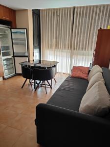 a living room with a couch and a table at Cozy Apartment close to the beach in beatiful area in El Perelló