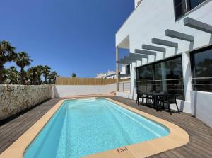 a swimming pool in the backyard of a house at Villa Son Blanc 6 in Sa Caleta
