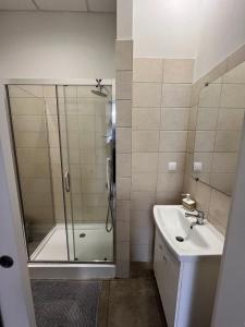 a bathroom with a shower and a sink at Apartamenty Na wzgórzu in Ińsko