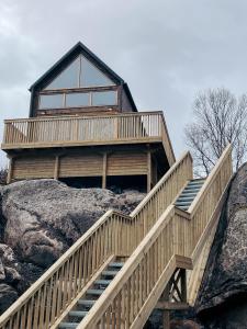 a house on top of a rock with stairs at Lofoten Cabins in Hopen