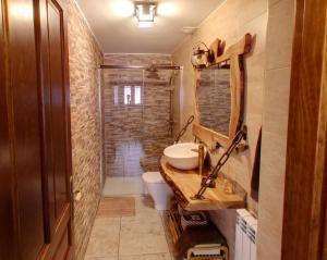 a small bathroom with a sink and a toilet at Apartamentos Ohana in Jadraque