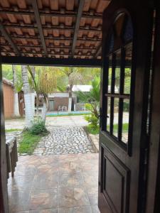 an open door of a house with a patio at Pesque pague pousada do Carlinho in Pinheiral
