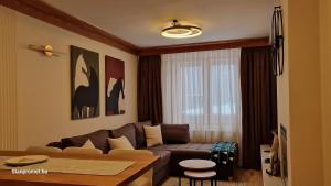 a living room with a couch and a table at Apartman 109 LUX - Aparthotel Vucko Jahorina private host in Jahorina
