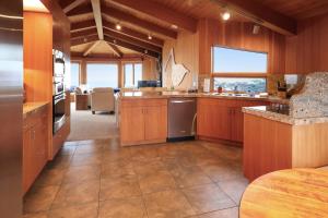 a large kitchen with wooden cabinets and a large window at The Brass Seahorse in Gualala