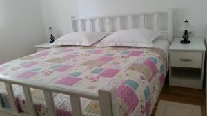 a bedroom with a bed with a quilt on it at Apartments Rustic in Biograd na Moru +37 photos