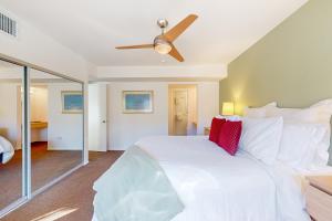 a bedroom with a white bed and a ceiling fan at Hermosa Hideaway Permit #39494 in Palm Springs +8 photos