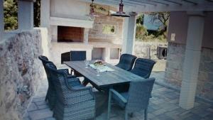 a dining table and chairs on a patio at Apartments Rustic in Biograd na Moru