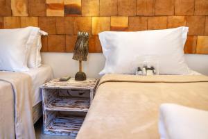 Säng eller sängar i ett rum på Awe Villa Boutique Trancoso