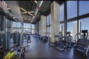 a gym with rows of treadmills and machines at Vibrant Studio Downtown Miami in Miami