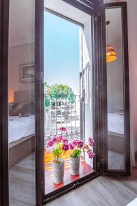 a mirror with two potted plants in a room at Edomus Gran Plaza Boutique in Seville