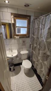 een badkamer met een toilet en een wastafel bij Hospedaje Leñas del Tolosa in Las Cuevas