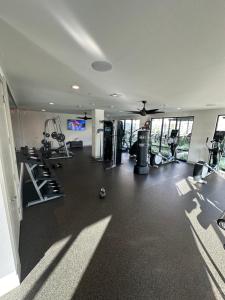 a gym with treadmills and machines in a room at Cozy Comfort Lux in Houston