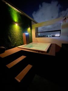 a hot tub on the deck of a house at night at Studio 27 in Santo Domingo