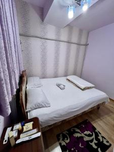 a small bed in a room with a curtain at Apartment in the centre of Yerevan for rent in Yerevan