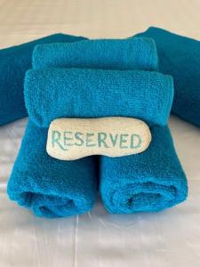 a blue towel with a sign that reads reserved at Bella Blue Bonaire 2 in Kralendijk