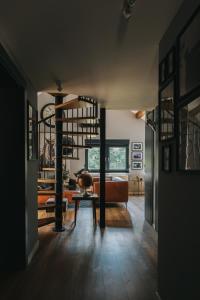 a living room with a couch and a table at The Loft / Hill View Modern Apartment in Samobor