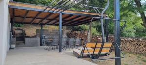 a group of chairs sitting under a pergola at Chata WUSAPL in Krahule