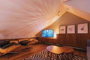 an attic living room with a ceiling with a popcorn at The Loft / Hill View Modern Apartment in Samobor
