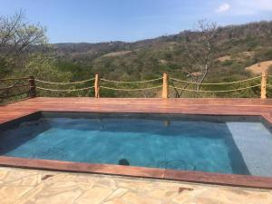 a small swimming pool on a wooden deck with a wooden fence at Jungle Farm, Digital Detox Cottage in Nicaragua in La Esperanza