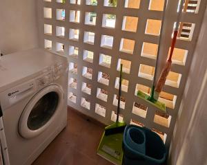 a washing machine in a room with a wall at Private Apartment & Pool - El Oasis Golf Resort - Fuente del Alamo in Murcia