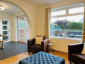a living room with chairs and a large window at Sea View Villa in Great Yarmouth