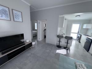 a large living room with a flat screen tv at Cosea Langebaan in Langebaan