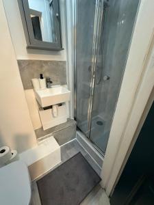 a bathroom with a sink and a shower at 10 Minutes to Central London Vaux in London