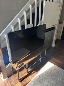 a large flat screen tv sitting on a entertainment center at Poppy Loft in Raleigh