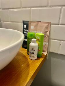 a bathroom counter with a sink and some products on it at Poppy Loft in Raleigh