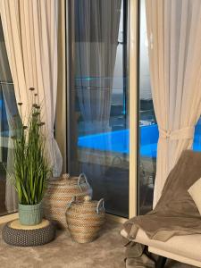 a living room with two baskets and a window at Marbella Resort in Al Ain