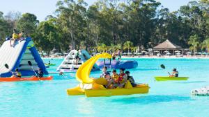 a group of people playing in a water park at Solanas Punta Del Este Spa & Resort in Punta del Este