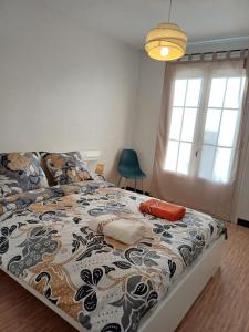 1 dormitorio con 1 cama con un edredón colorido en l'auberge agenaise de 1 a 8 personnes, en Agen