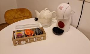 a table with a tea kettle and a box on it at Ap CALAS , No2 2B Parter in Râşnov