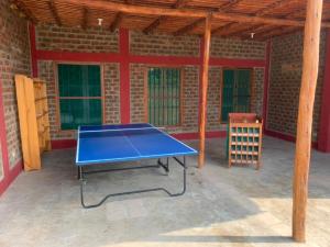 a blue ping pong table sitting inside of a building at Casa de Campo La Escondida in Chincha Baja