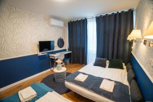Posteľ alebo postele v izbe v ubytovaní Apartament Hotel Grzybowska 9