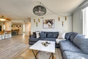 a living room with a blue couch and a table at Private Patio, Community Perks Palm Springs Condo in Palm Springs