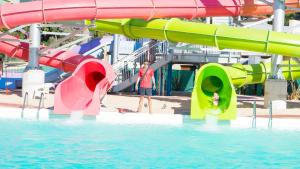 a water park with a water slide in the water at Solanas Green Park Spa & Resort in Punta del Este