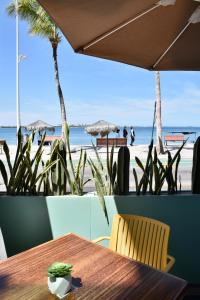 a table and chairs with the beach in the background at Malecón 1680 in La Paz