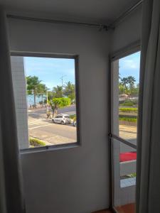 a room with a window with a view of a street at Apart Ponta Verde in Maceió