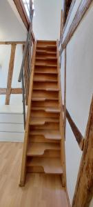 a wooden staircase in a room with wooden floors at Zentrale Altbauwohnung mit Flair in Schwäbisch Hall